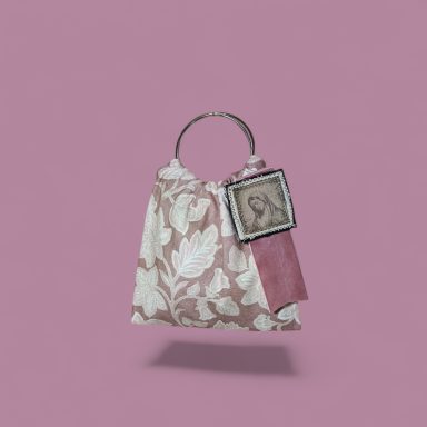Rose Dream Bolso con diseño floral en tonos rosa y un retrato en una etiqueta. Fondo rosa.